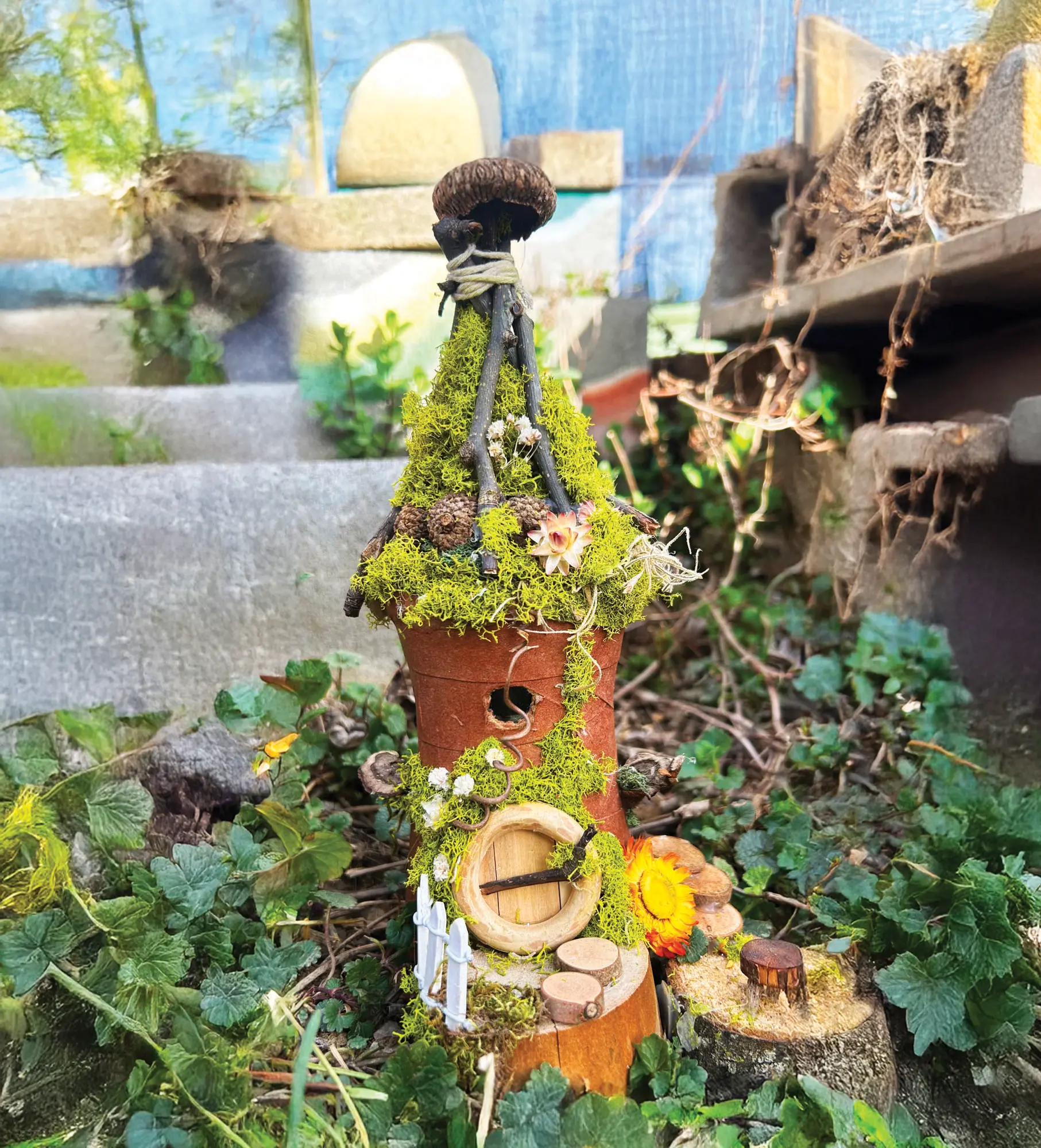 a crafted fairy house in a garden